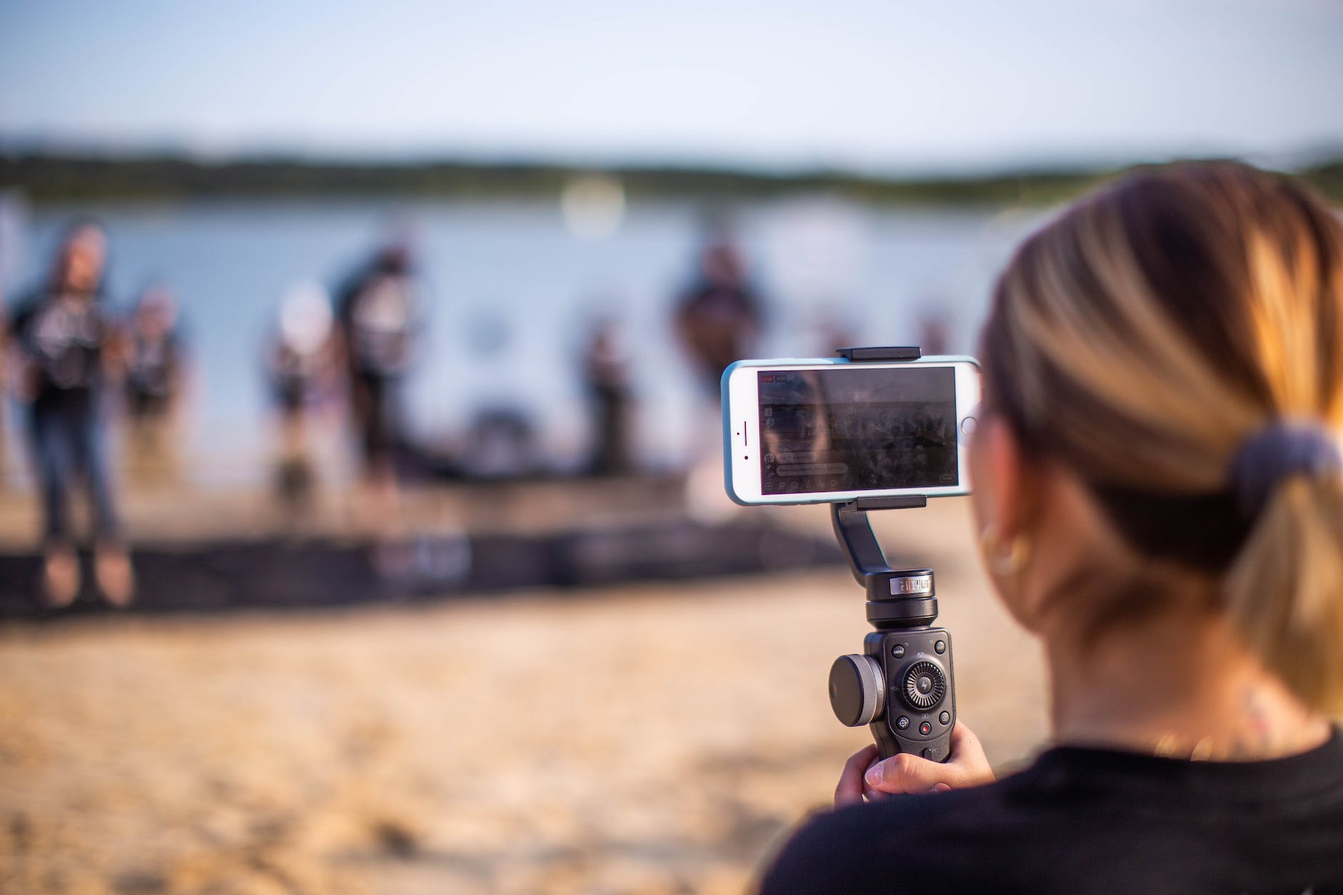 anonymous woman shooting performance on beach